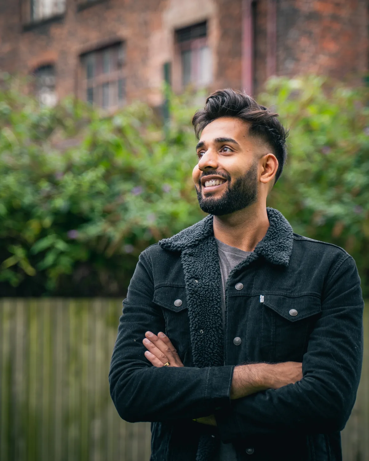 Dr Kiran Morjaria laughing candidly on a Manchester street